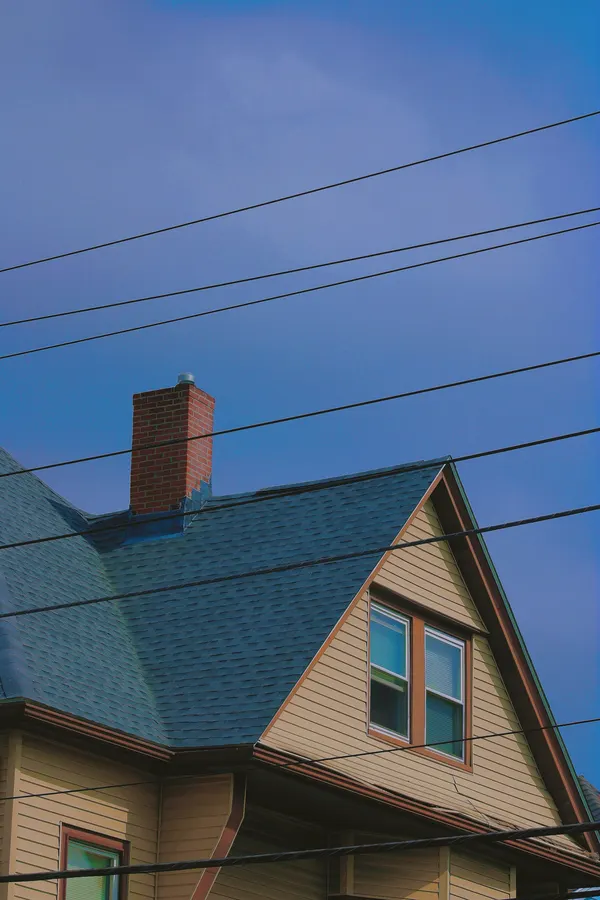 Shingle roof with a brick chimney